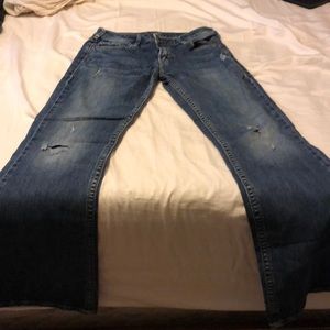 Silver jeans with small holes